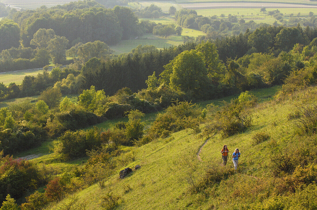 Two women hiking in an idyllic landscape, Franconian Switzerland, Bavaria, Germany, Europe