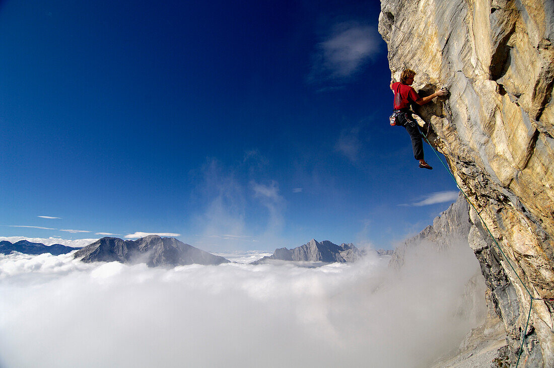 Climber at Schuesselkar rock face in the sunlight, Tyrol, Austria, Europe