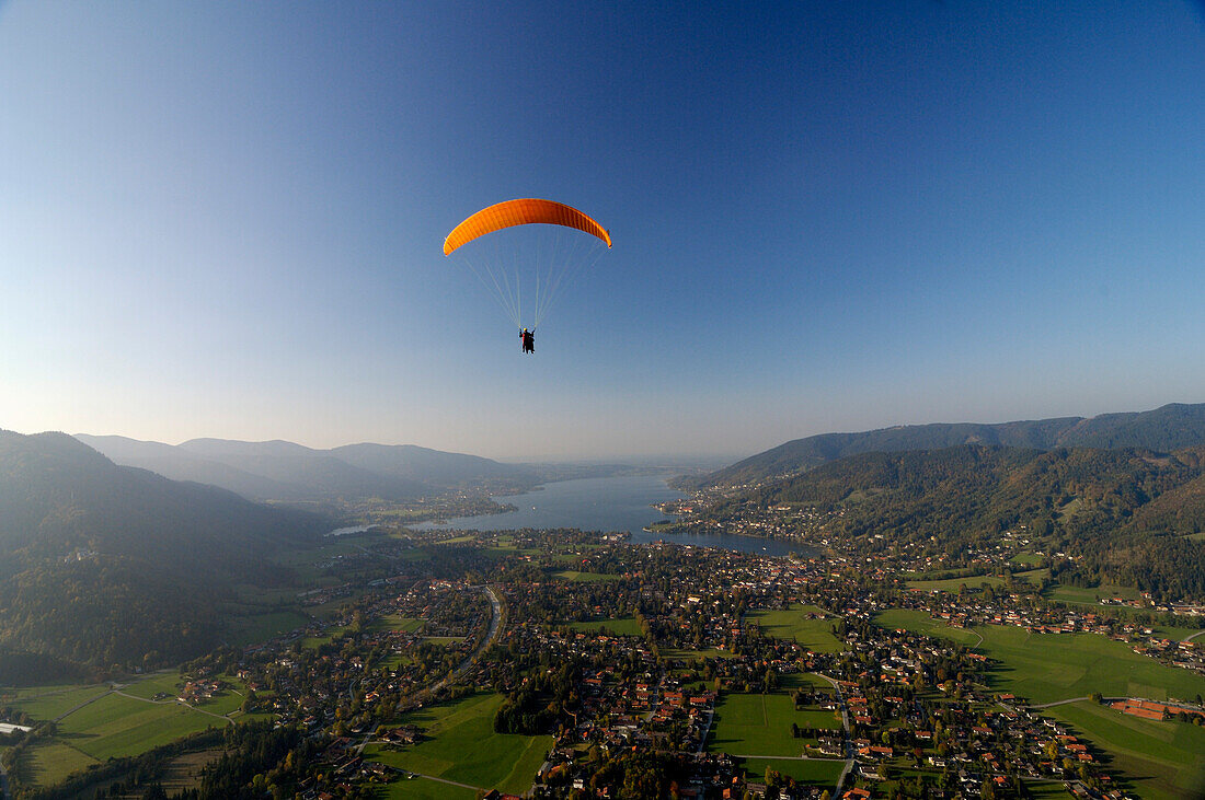 Person paragliding near Lake Tegernsee, near Rottach-Egern, Tegernsee, Upper Bavaria, Bavaria, Germany