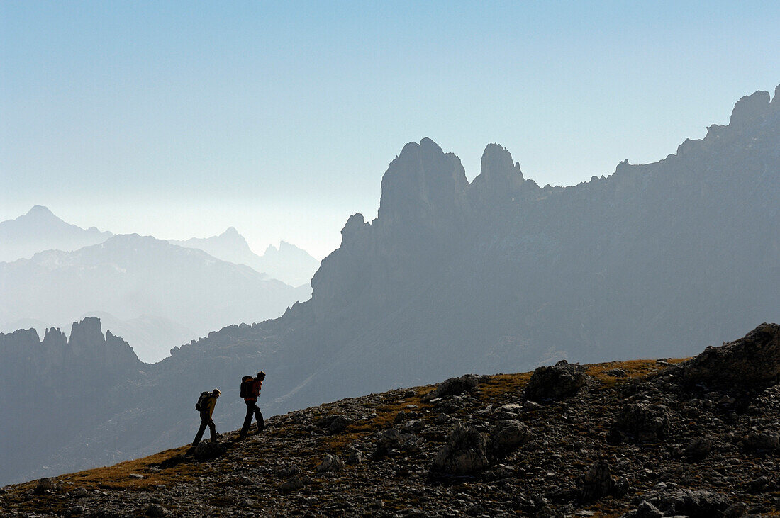 Couple hiking in the mountains, Val di Fassa, Rosengarten, Dolomites, Trento, South Tyrol, Italy