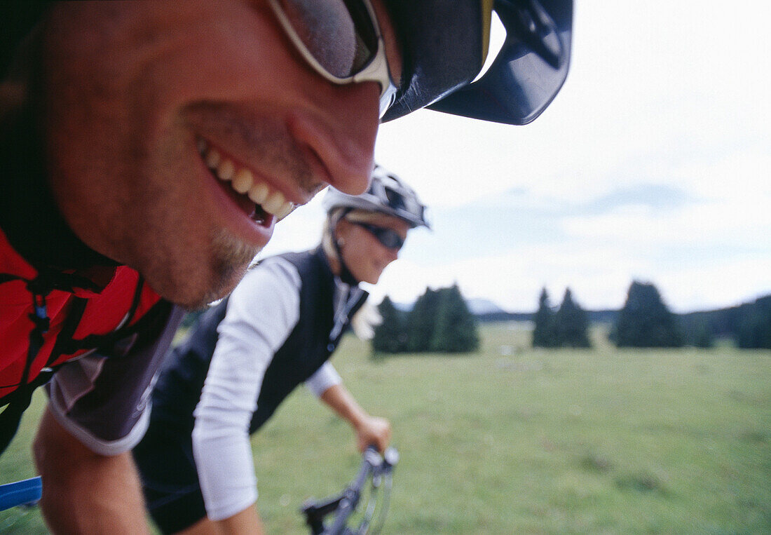 Couple mountain biking near lake Lago di Levico, Valsugana, Trentino-Alto Adige/Südtirol, Italy