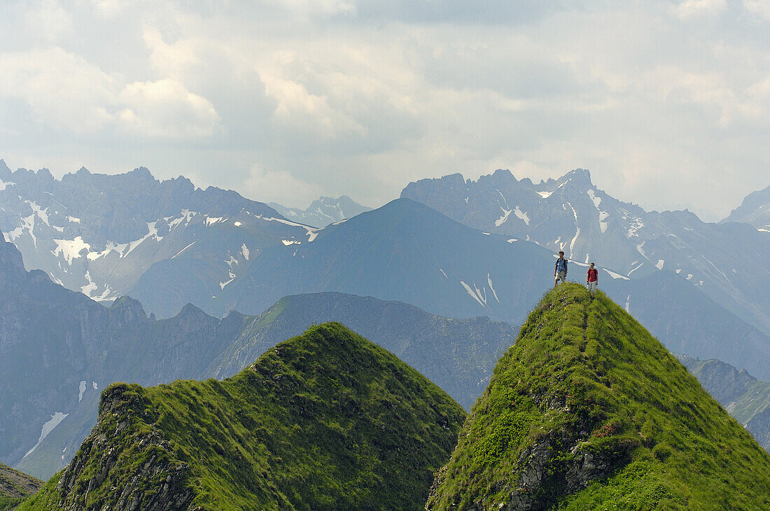 Hikers on hilltop, Allgaeu Alps, Bavaria, Germany
