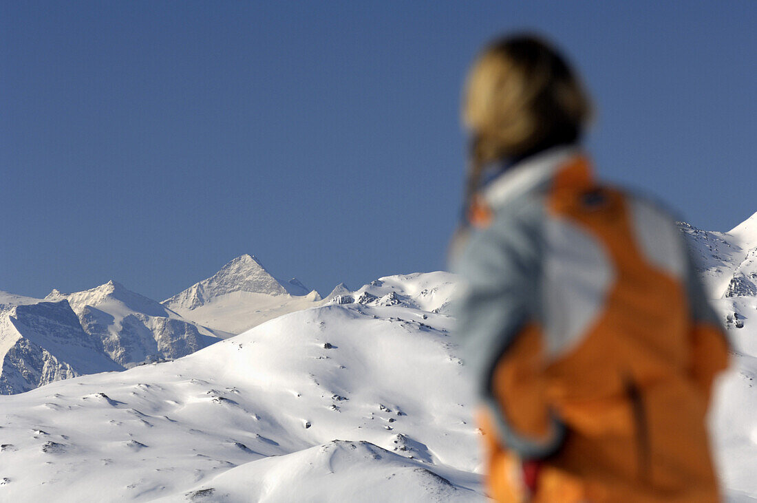 Woman looking at snow-covered mountain scenery, Fuegen, Zillertal, Tyrol, Austria