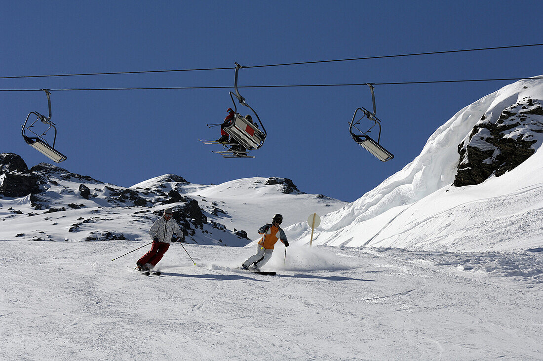 Skiers on slope, chairlift in background, Fugen, Zillertal, Tyrol, Austria