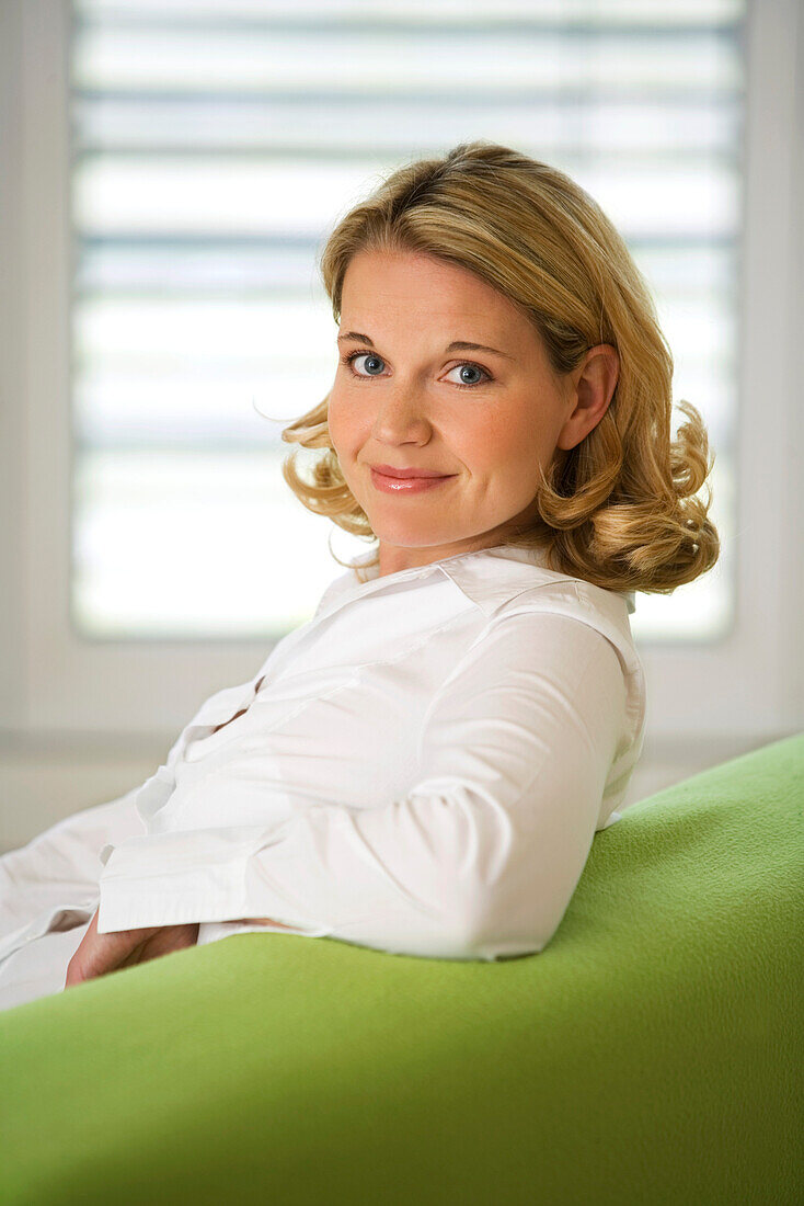 Woman on couch looking at camera