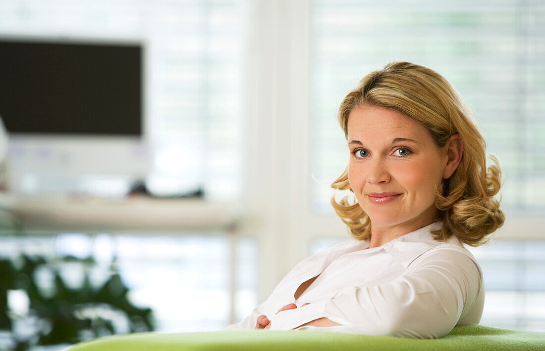 Woman on couch looking at camera