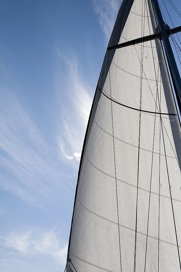 Clouds and sail against a blue, summer sky in The Gulf Islands of British Columbia in August 2008. The sail is a Yankee foresail.