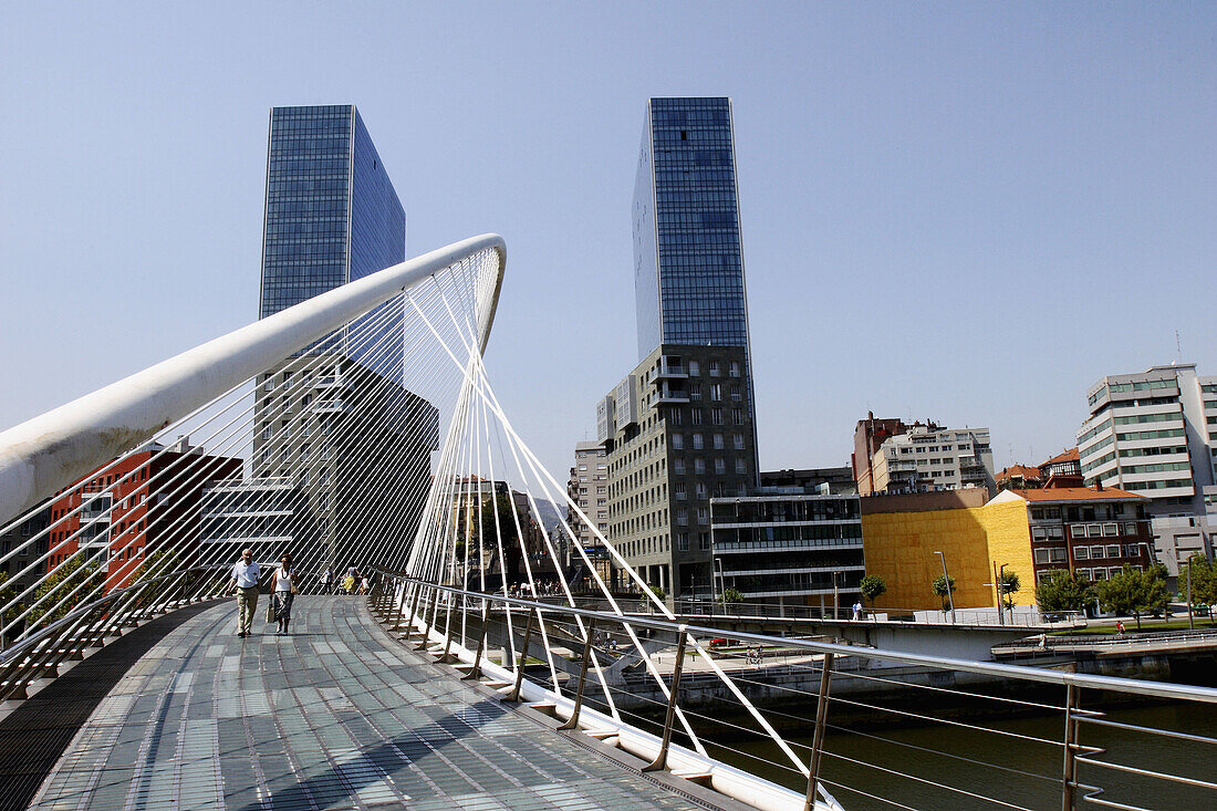 Zubizuri (White Bridge) footbridge by Santiago Calatrava over River Nervion and Isozaki Atea twin towers in background, Bilbao. Biscay, Basque Country, Spain