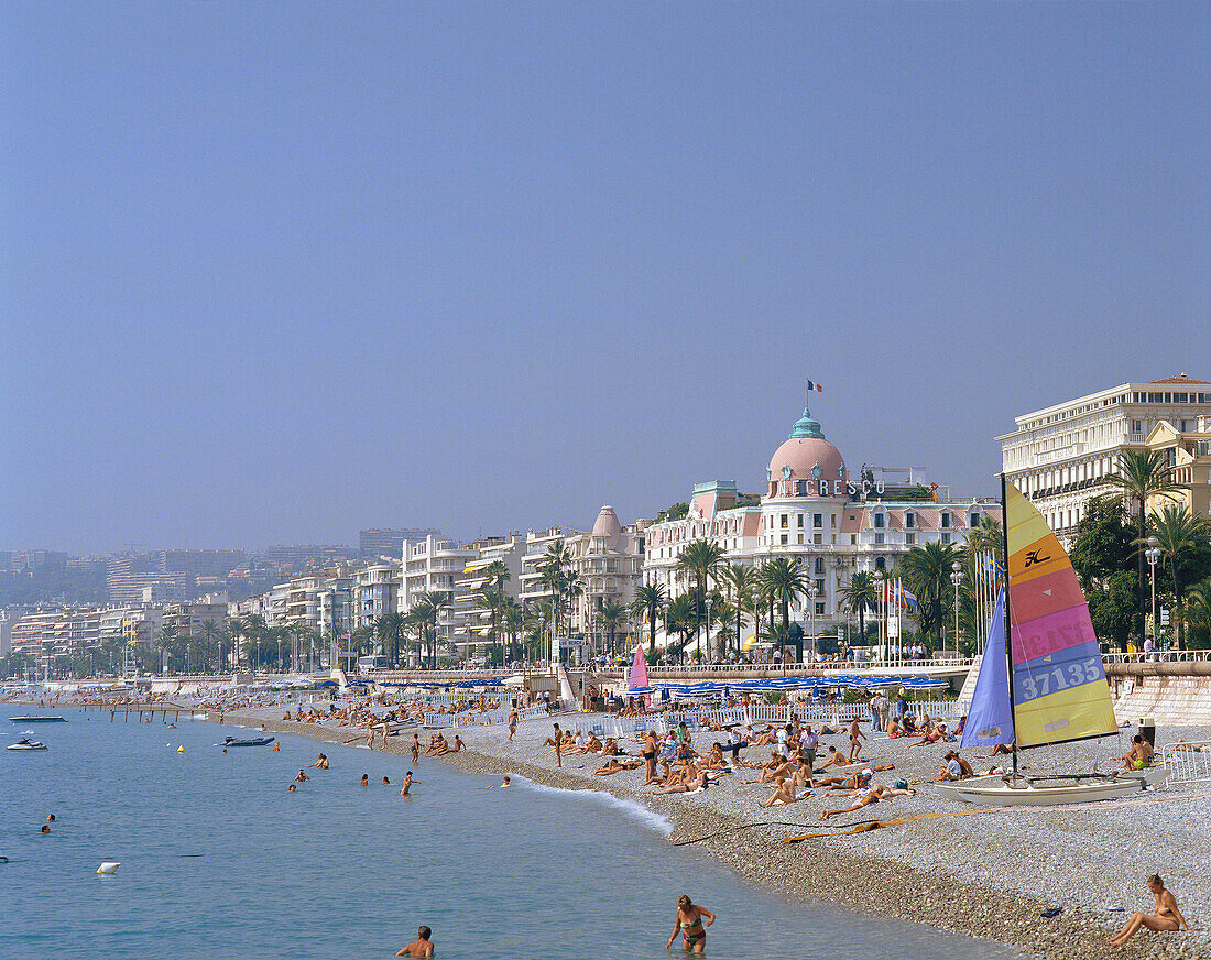 Beach scene with Hotel Negresco, Nice, Cote d'Azur, France