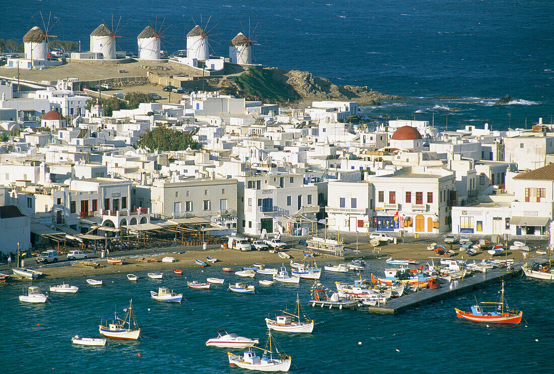 View over harbour and town to windmills, Mykonos Town, Mykonos Island, Greek Islands