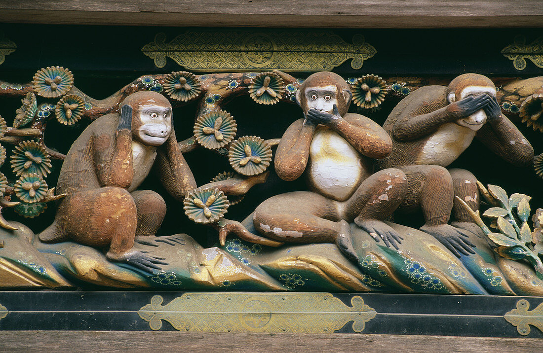 Statues of the three wise monkeys embodying the proverbial principle to see no evil. Hear no evil. Speak no evil. Tosho-gu shrine. Nikko. Japan