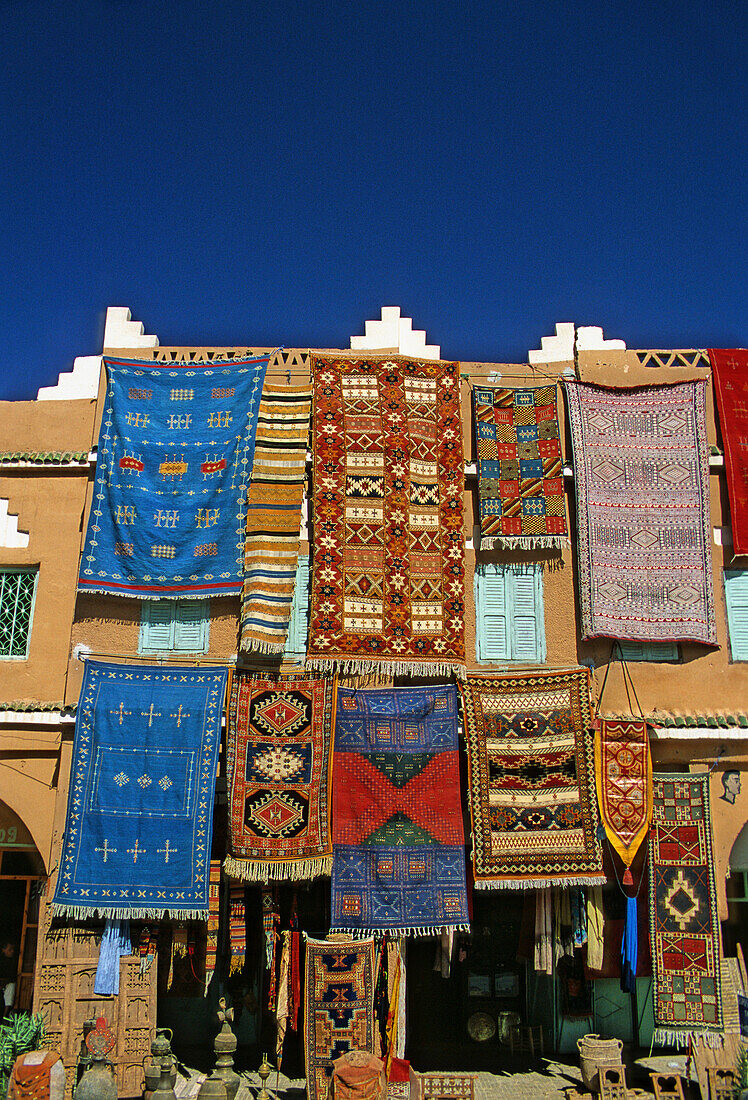 Morocco, Middle Atlas village, carpets on storefront display