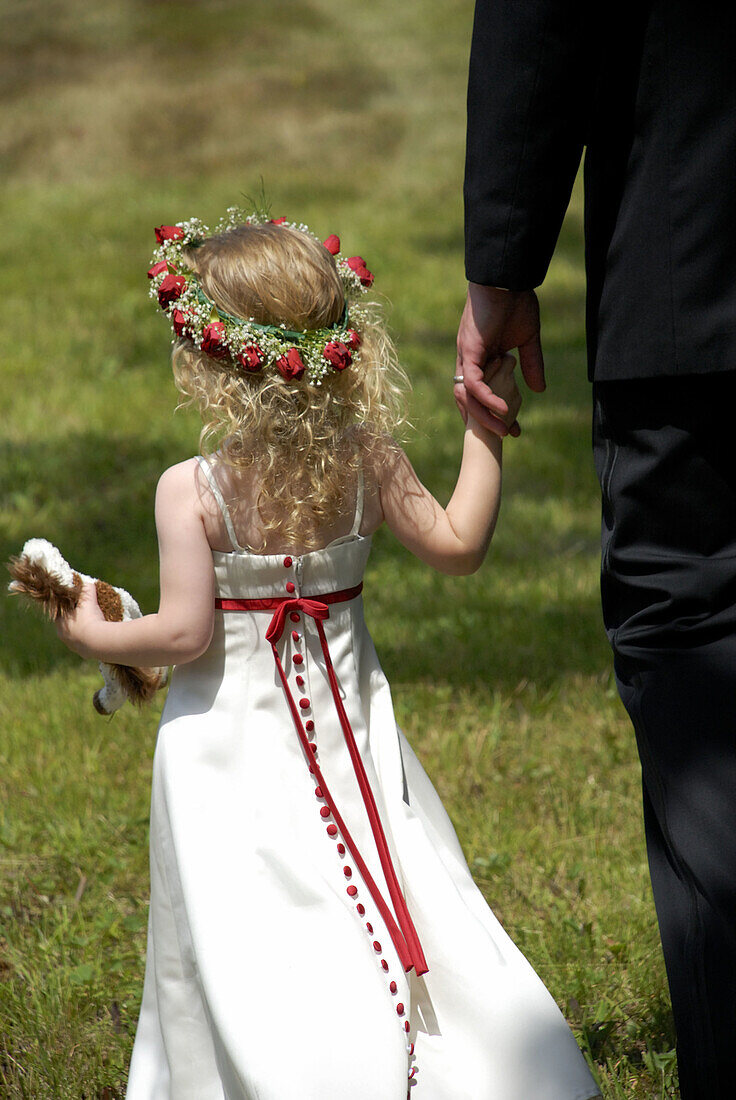 Girl holding fathers hand