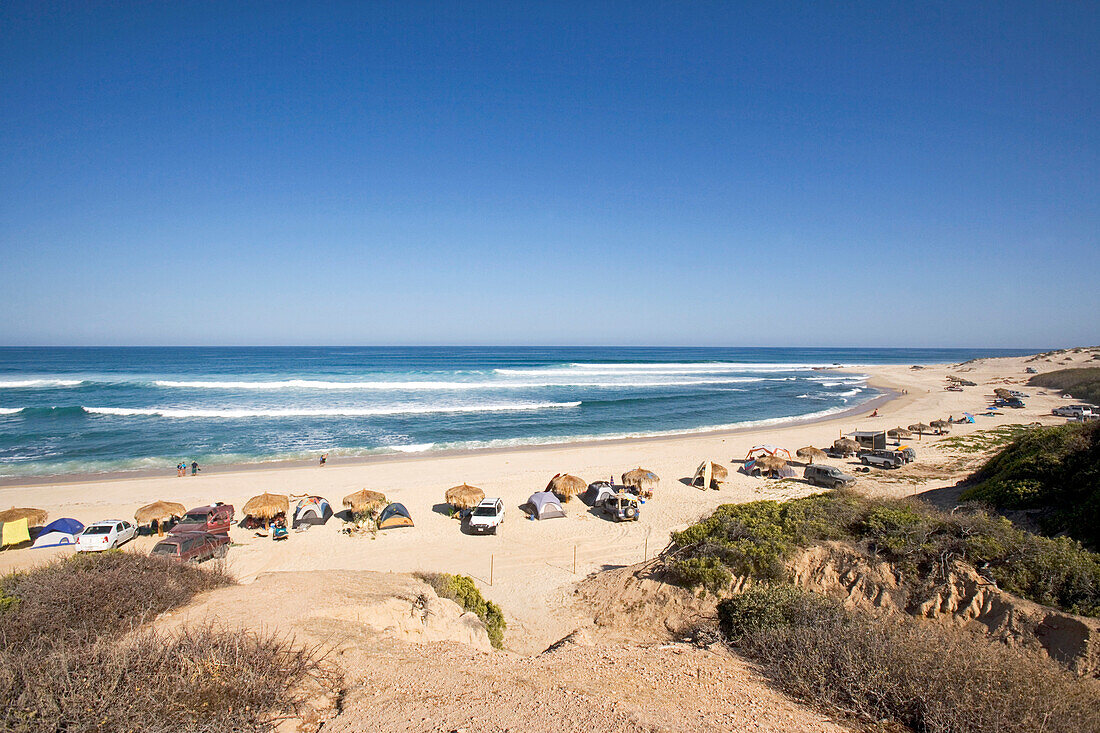 View from above towards a surfbeach with people camping, Nine Palms, Baja California Sur, Mexico