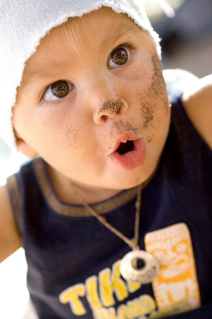 Portrait of a 14 month old girl that has been playing in the sand and looks excited, Punta Conejo, Baja California Sur, Mexico