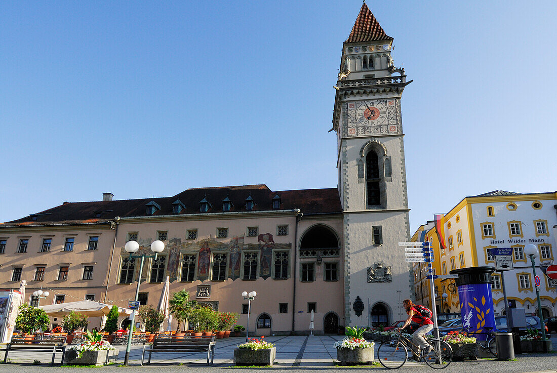 Female cyclist passing town hall, Danube Cycle Route Passau to Vienna, Passau, Lower Bavaria, Bavaria, Germany