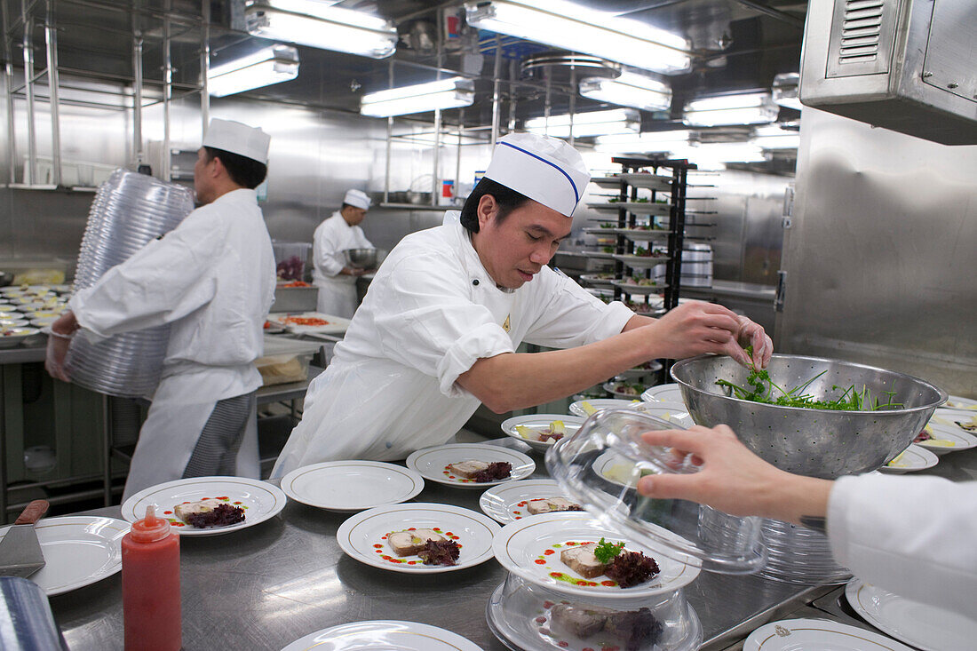 Chefs preparing the starter in the galley, ships kitchen, cruise liner, Queen Mary 2