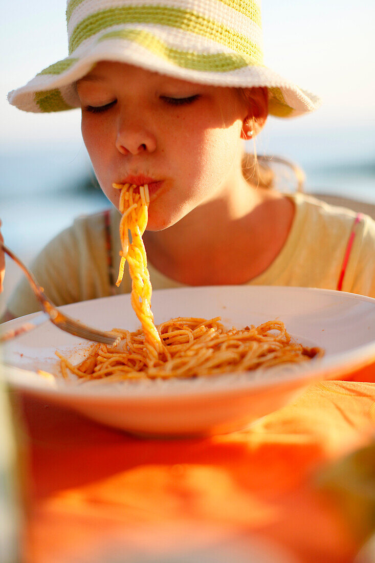 Girl eating spaghetti, Formentera, Balearic Islands, Spain