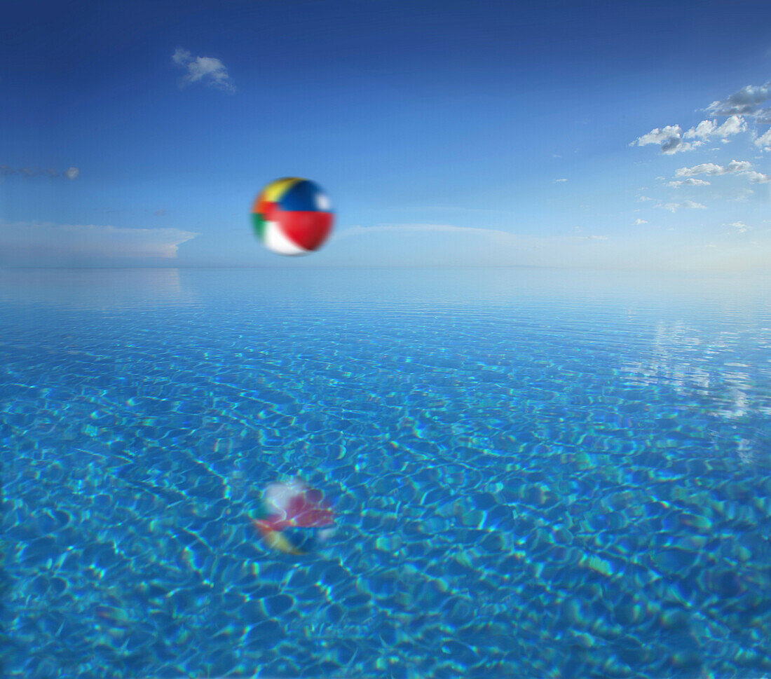 Beach ball above the water of an infinity pool, Bohol, Philippines, Asia