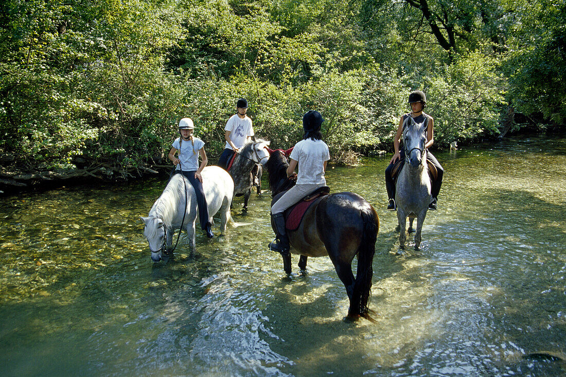 Kinder auf Pferden im Fluss Sorgue, Vaucluse, Provence, Frankreich, Europa