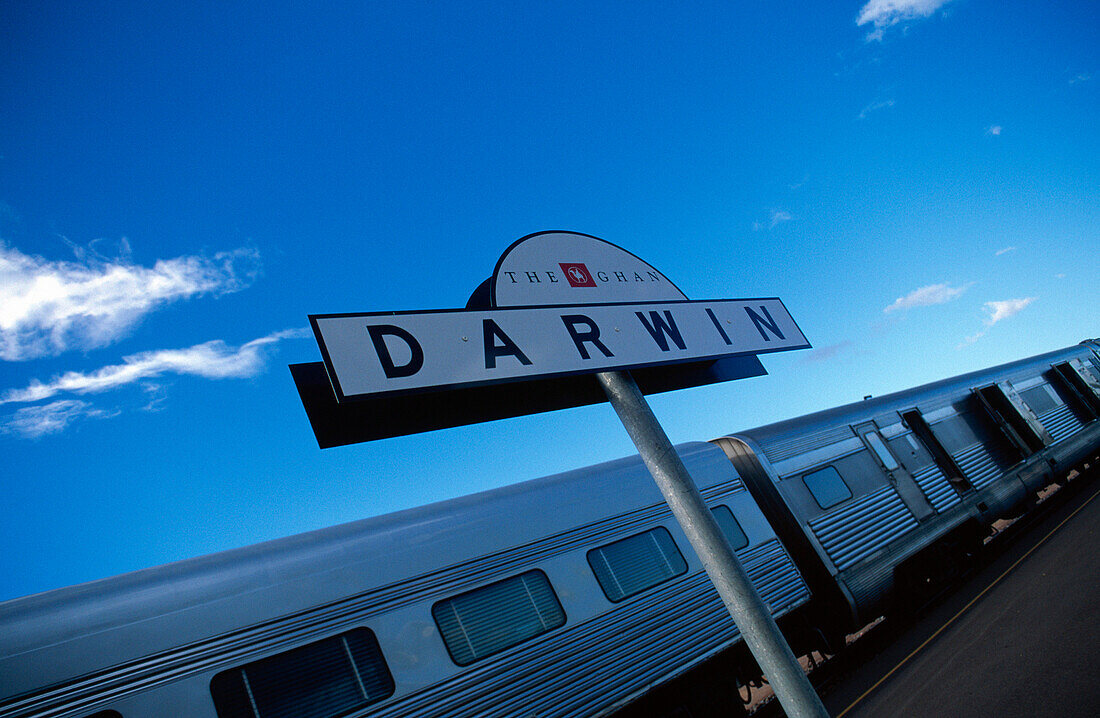 Railway station sign in front of The Ghan transcontinental train, Darwin, Northern Territory, Australia