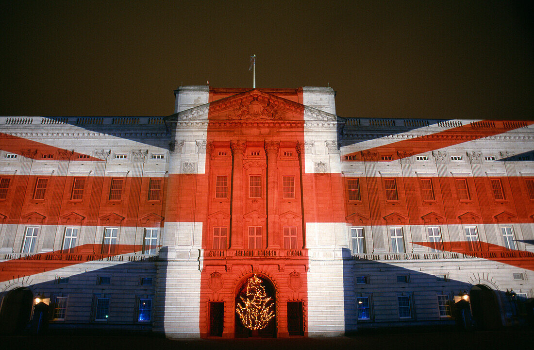 Buckingham Palace illuminated with Union Jack Flag at night, London, UK, England