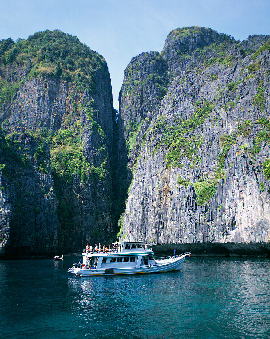 Pleasure boat in front of steep cliffs, Phuket, Ko Phi Phi Island, Thailand