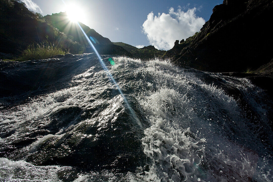 Waterfall in the mountains in the sunlight, , Barranco del Charco Azul, El Risco valley, Parque Natural de Tamadaba, Gran Canaria, Canary Islands, Spain, Europe