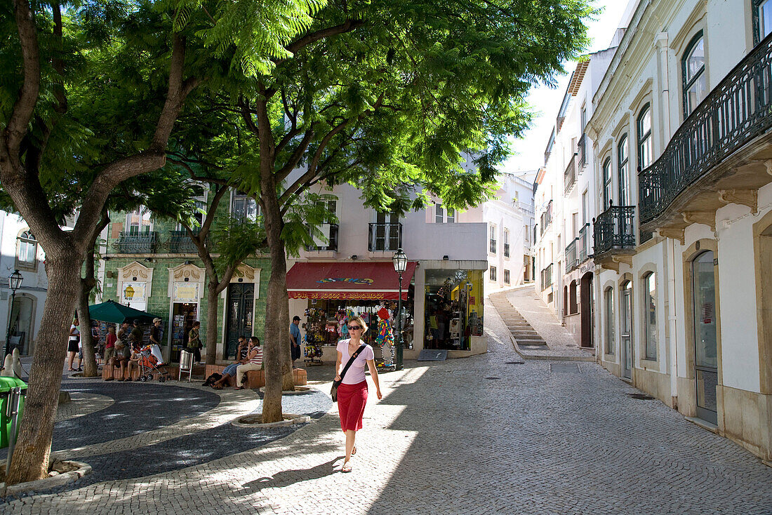 Young women in Lagos, town square with trees, MR, Lagos, Algarve, Portugal