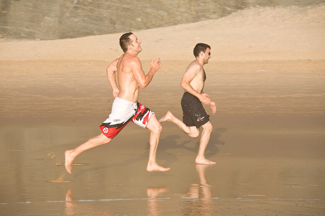 Two men running on the beach, Beach Praia do Castelejo, Vila do Bispo,  Algarve, Portugal