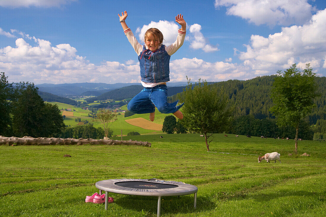 Child on trampoline at Schwärzenbach, Titisee-Neustadt, Summer, Black Forest, Baden-Württemberg, Germany, Europe