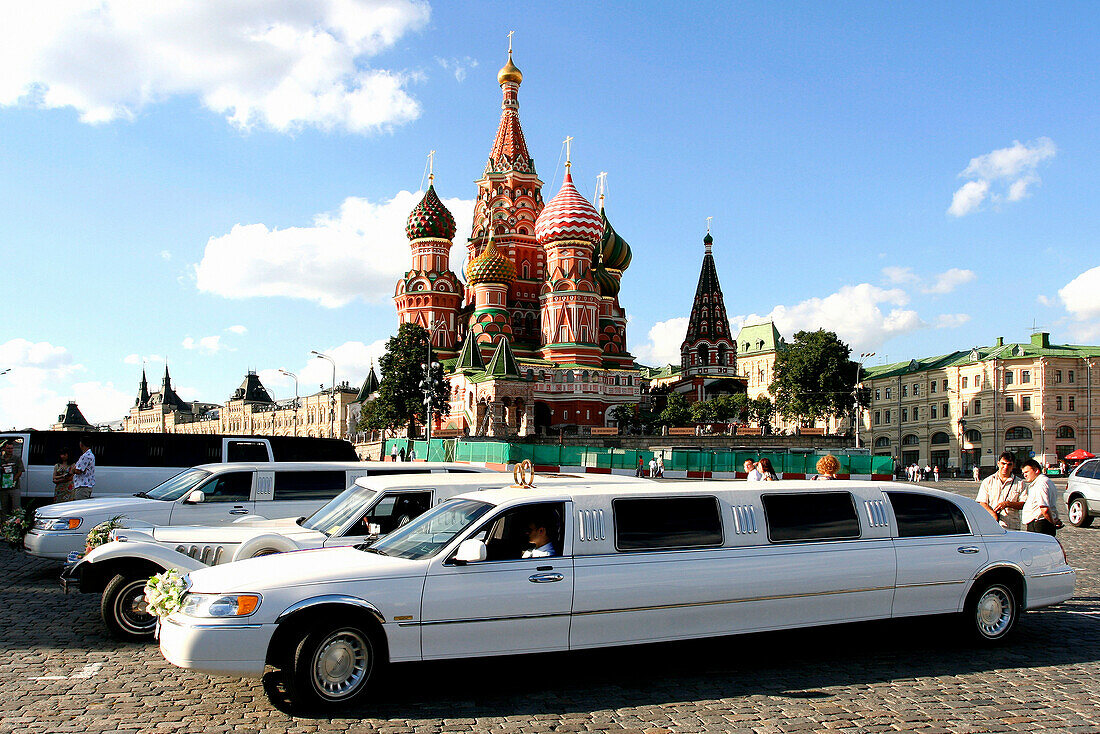 Luxury cars in front of St Basil's Cathedral, Moscow, Russian Federation