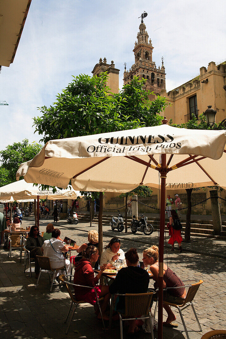 Cafe on Avenida de la Constitucion with Cathedral in background, Seville, Andalucia, Spain