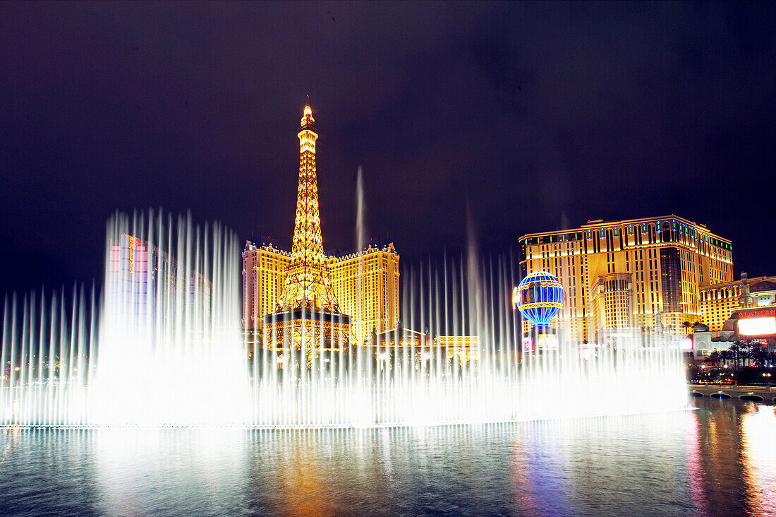 Paris Hotel and Casino with fountains playing at night, Las Vegas, Nevada, USA