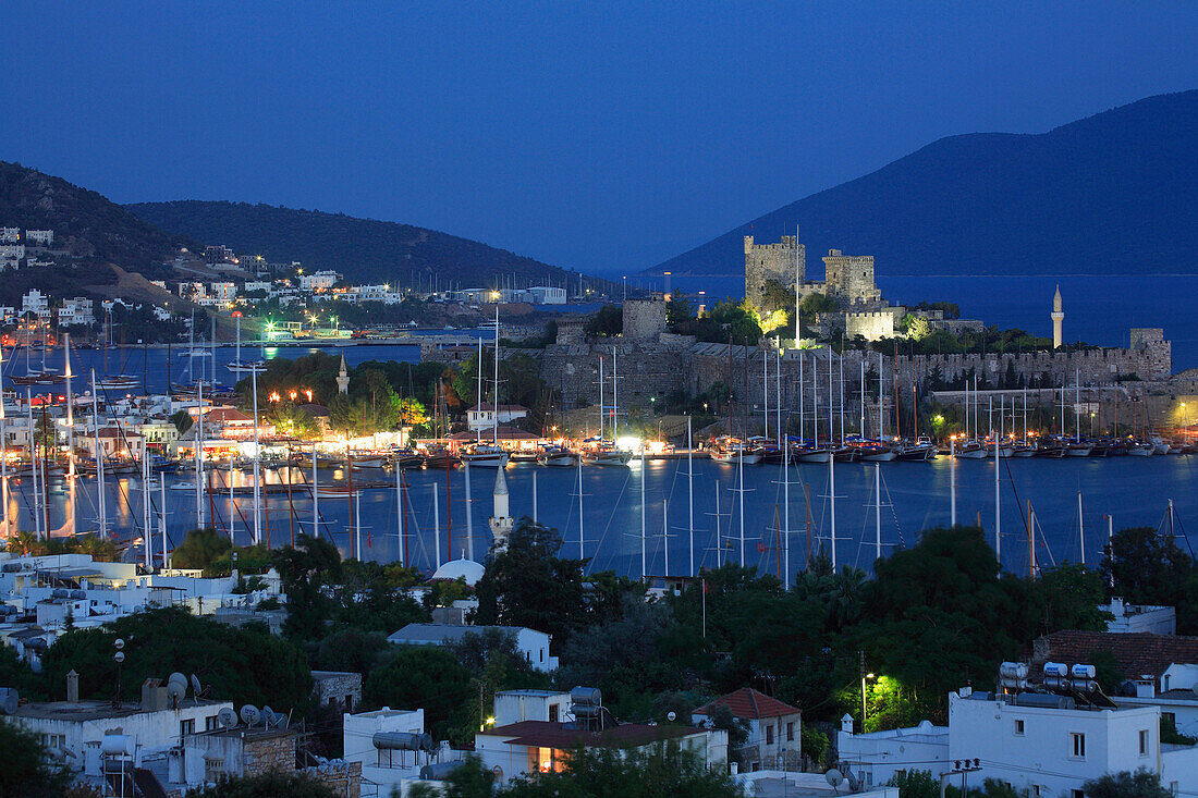 View over town and harbour to Castle of St Peter at night, Bodrum, Aegean, Turkey