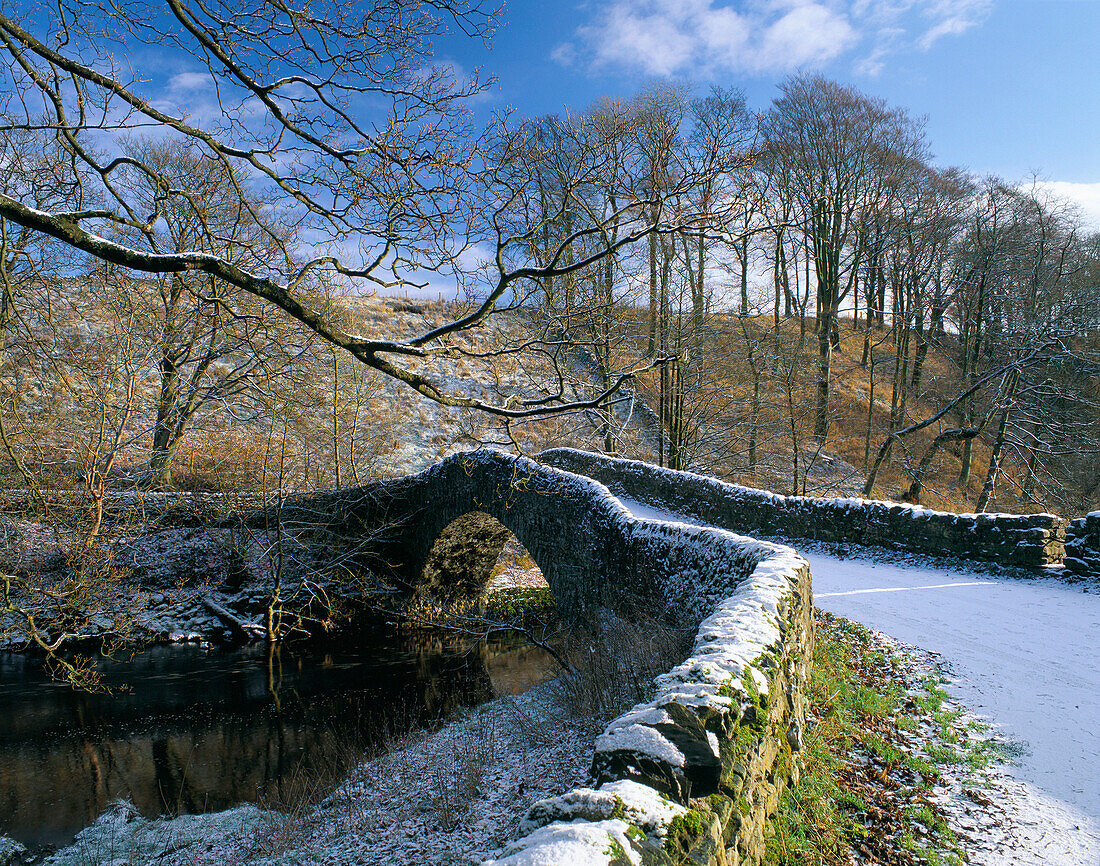 Ancient packhorse bridge in winter, Stainforth, Yorkshire, UK, England