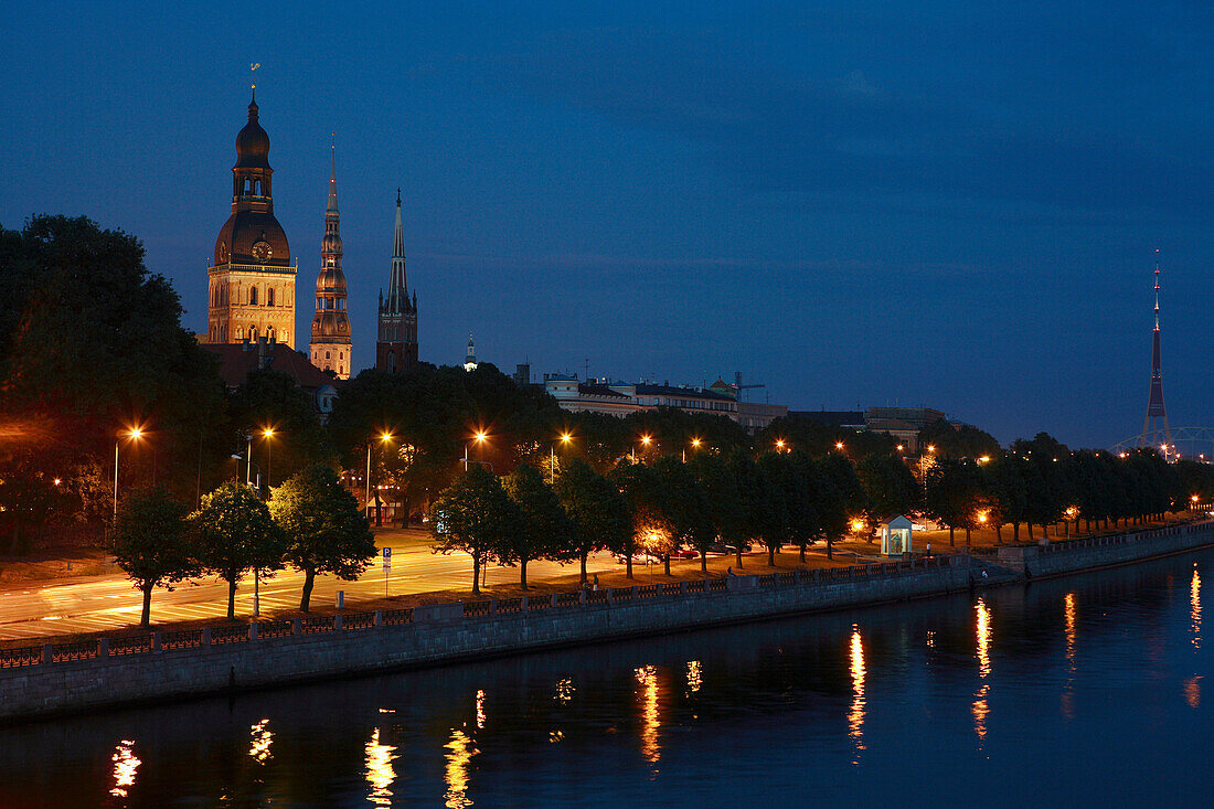 Daugava River with view of castle and churches at night, Riga, Latvia