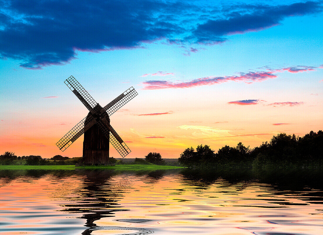 Lake scene with windmill at sunset, Olsztyn, Poland