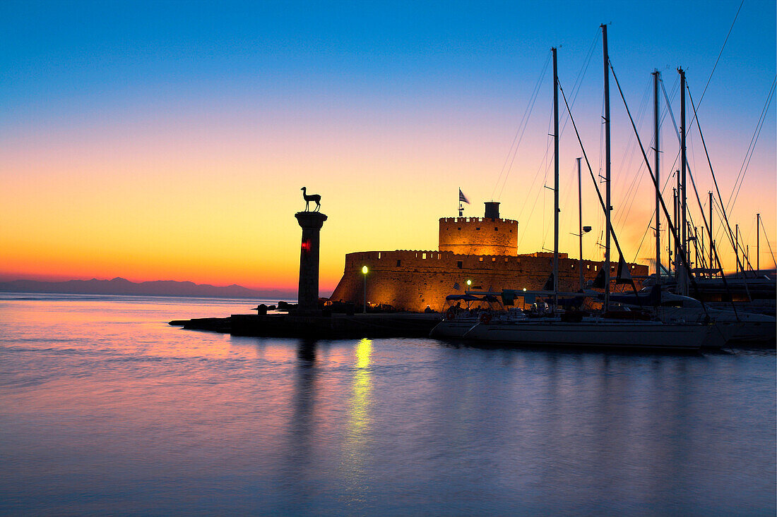 Mandraki Harbour with St Nicholas Fort at sunset, Rhodes Town, Rhodes Island, Greek Islands