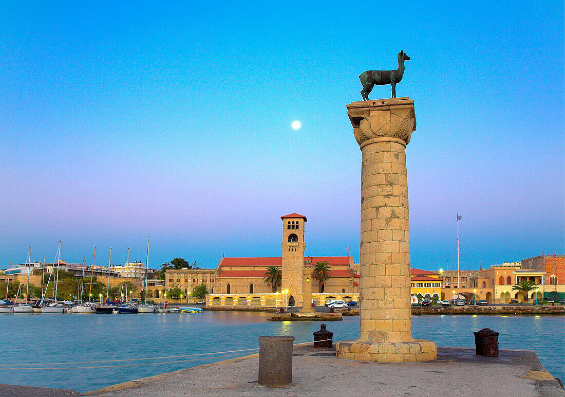 Mandraki Harbour with deer statue and St Nicholas Fort at dusk, Rhodes Town, Rhodes Island, Greek Islands