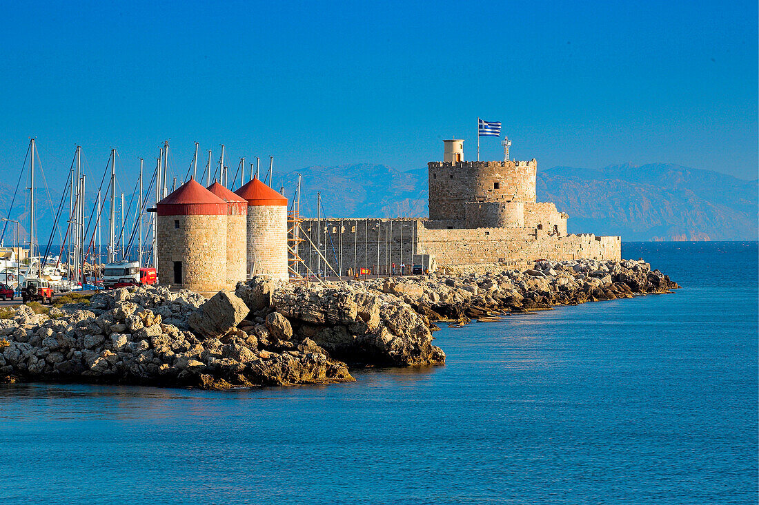 Mandraki Harbour entrance with castle and windmills, Rhodes Town, Rhodes Island, Greek Islands