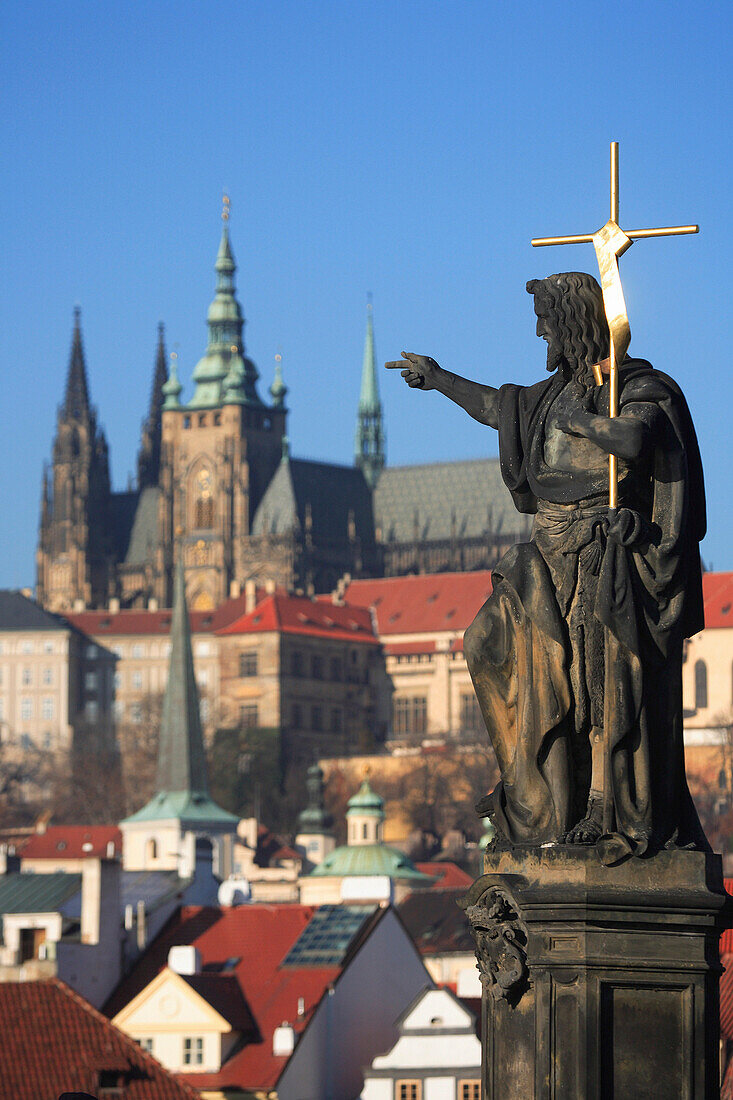 Statue on Charles Bridge with Castle and Cathedral, Prague, Czech. Republic