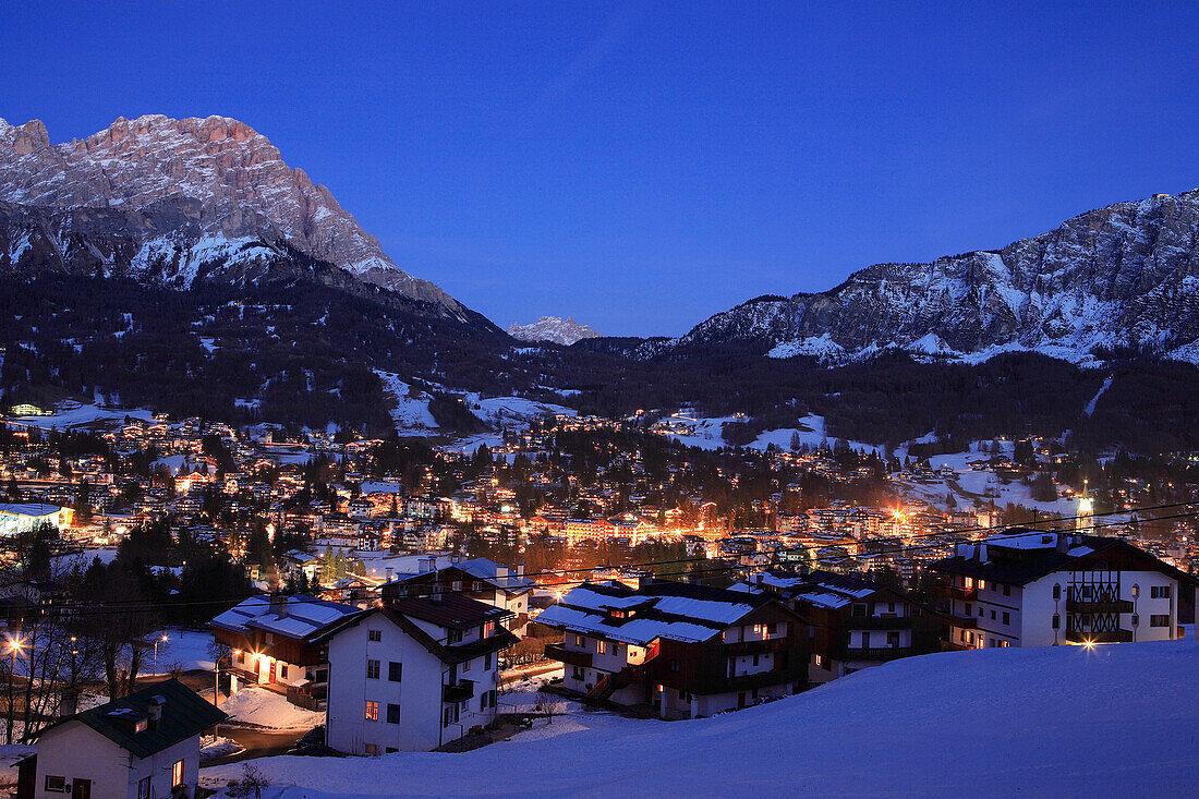 View of town and Dolomites at night in winter, Cortina d'Ampezzo, Trentino-Alto Adige, Italy