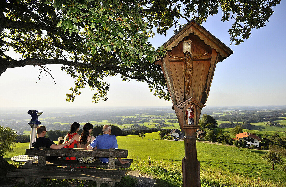 Four persons enjoying view from mount Samerberg, Toerwang, Chiemgau, Bavaria, Germany