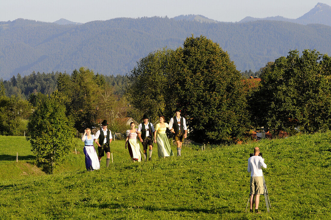 People in traditional costumes on a meadow, Reutberg abbey, Bavaria, Germany