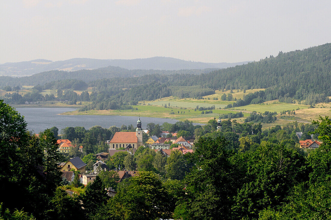 View at the town Sosnowka in front of a lake at an idyllic scenery, Sosnowka, Bohemian mountains, lower-Silesia, Poland, Europe