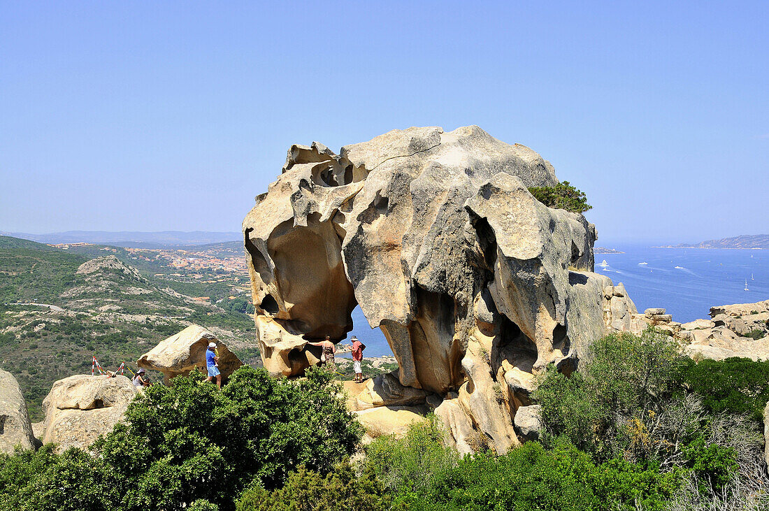 Tourists at the rock formation Capo d´Orso in the sunlight, Palau, North Sardinia, Italy, Europe