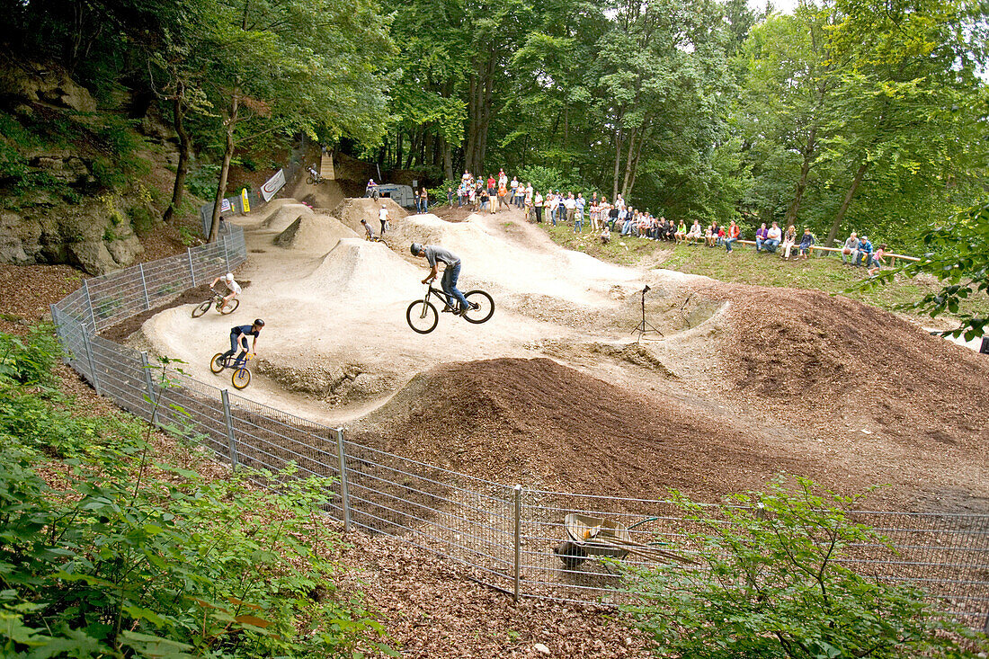 Teenagers jumping with dirt bikes, Starnberg, Bavaria, Germany