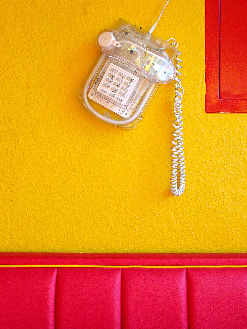 Telephon,  yellow wall,  red sofa,  snack bar,  fast-food place