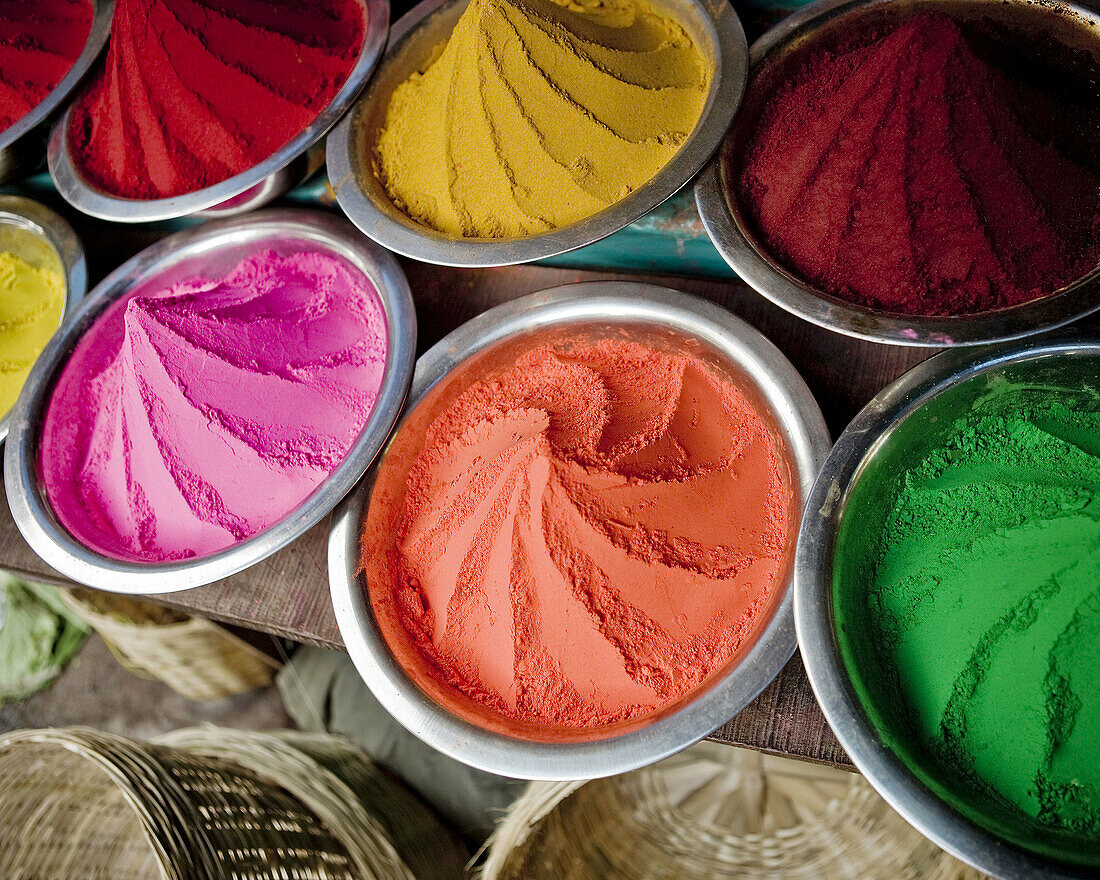 a close up picture of colored dyes in market in india.